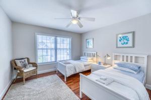 a bedroom with two beds and a ceiling fan at Spacious Mountain House - 10 minutes from Asheville & Biltmore! in Asheville