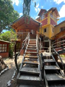 a set of wooden stairs leading to a house at Mayan Casas in San Marcos La Laguna