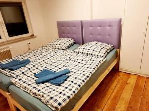 a bed with two blue pillows on top of it at Apartment with parking in Berlin 11 in Berlin
