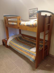 two bunk beds in a room with a bed at Avocado house in Finikounta