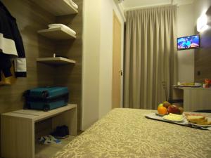 a room with a bed and a tv at Hotel Siena in Milan