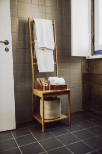 a towel rack in a bathroom with a towel at Estação Ferroviária de Lourido in Celorico de Basto