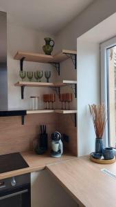 a kitchen with wooden shelves and a counter top at Luxury Stable 1 in Rēzekne