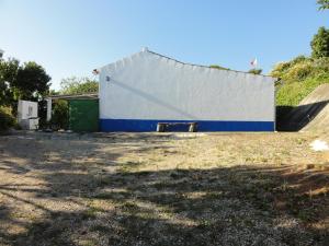 a white and blue building with a ramp next to it at Casa do Moleiro in Santiago do Cacém