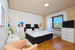 a bedroom with a bed and a television in it at DUBROVNIK HAUS suites in Dubrovnik