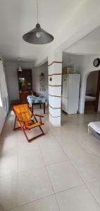 a living room with a chair and a refrigerator at The Cozy Yard in Nea Potidaea