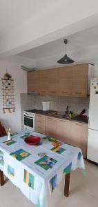 a kitchen with a table with a table cloth on it at The Cozy Yard in Nea Potidaea +14 photos