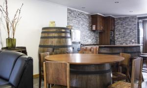 una cocina con mesa y 2 barriles de vino en Casa Lagar de Pedra T2, 
