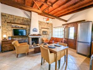 a living room with a table and a refrigerator at Relaxing Sea View Home in Kalandra