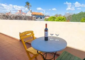 a table with a bottle of wine and two glasses at VILLA VICTORIA OLD TOWN in Rhodes Town