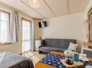 a living room with a couch and a table at Villa Sul Mare in Dębki