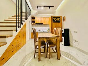 a kitchen with a wooden table and chairs at Palm&Ocean Canggu in Canggu