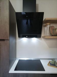 a television sitting on a shelf in a kitchen at glamhouse in Nizza Monferrato