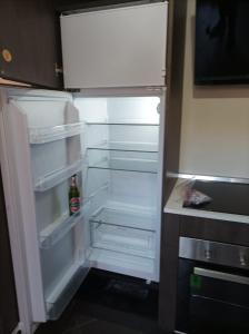 an open refrigerator with a bottle of beer in it at glamhouse in Nizza Monferrato