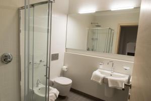 a bathroom with a toilet and a sink and a mirror at Residenza Luigina in Varenna +22 photos