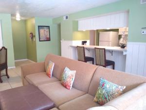a living room with a couch and a kitchen at TWO Bedroom TWO Bath Family Condo - Sleeps Four - Unit B - Private Beach in St Petersburg