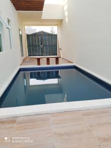 a swimming pool in the middle of a house at Condominio Casas Mandala in Costa Esmeralda