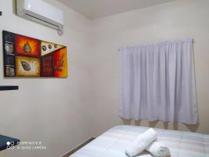 una camera da letto con un letto e un dipinto sul muro di Condominio Casas Mandala a Costa Esmeralda