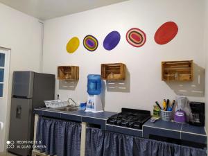 a kitchen with a stove and plates on the wall at Condominio Casas Mandala in Costa Esmeralda