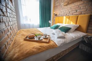 a bed with a tray of food on it at Czocha Studio Apartment in Leśna