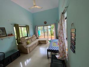 a living room with a couch and a table at 2BHK Luxurious Villa with Pool in Shenwa