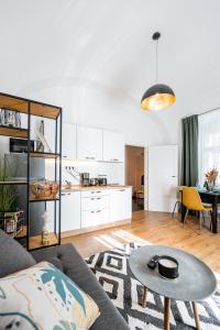 a living room with a couch and a table at Hlavna Apartment Kosice in Košice