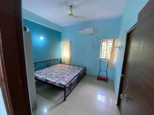 a bedroom with a bed in a blue room at 2BHK Luxurious Villa with Pool in Shenwa