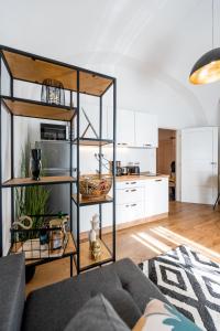 a living room with a couch and a kitchen at Hlavna Apartment Kosice in Košice