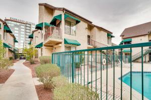 a apartment building with a swimming pool and a fence at Vacation Rental Near Las Vegas Strip With Pool! in Las Vegas