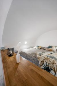 a bedroom with a large bed with a wooden table at Hlavna Apartment Kosice in Košice