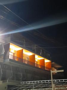 a building with lights on top of it at night at Anxhelos Hotel in Himare