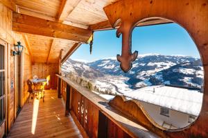 a view from the balcony of a cabin with a large window at Magdalena Hütte in Hippach