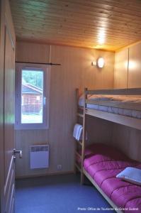 a small room with two bunk beds and a window at Camping La Chapelle 