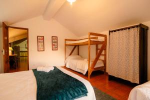 a bedroom with two beds and a bunk bed at A Saboeira - Turismo Rural in Belver