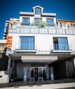 a white building with a balcony on top of it at Hotel Art Santander in Santander