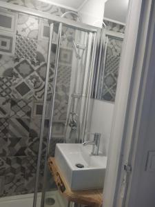 La salle de bains est pourvue d'un lavabo et d'une douche. dans l'établissement Porto Grand Sasimi House, à Porto