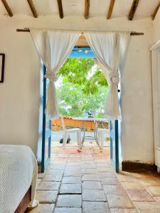 a bedroom with a door open to a patio at Casa de la Piedra in Barichara