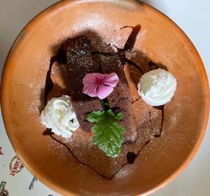 a chocolate dessert with whipped cream and a flower on top at Mayan Casas in San Marcos La Laguna