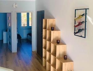 a room with a book shelf with wine bottles at Przystanek Ustroń in Ustroń