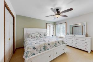 a bedroom with a bed and a ceiling fan at Trinity Place Treasure in Ocean Pines