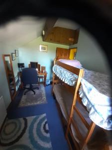 a room with two bunk beds and a desk at Old Coach House in Matlock