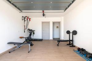 a gym with two treadmills and two exercise bikes at Appartamento-L'elicriso in Scano Montiferro