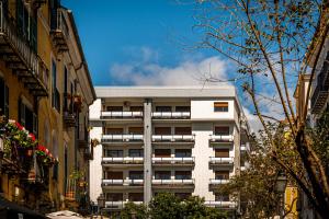 a tall white building in the middle of a city at B&B il Duca d'Amalfi in Salerno