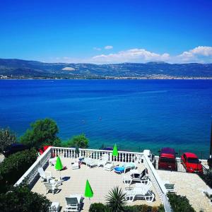 特羅吉爾的住宿－Villa Fjaba - by the sea - with the big terraces & great sea view，海滩上设有椅子和遮阳伞,水面