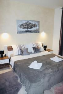 a bedroom with a large bed with a tree on it at Iva apartman sa bazenom in Zemuniki