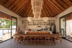 a kitchen with a large wooden table and chairs at Casa Mar Bacalar in Chetumal
