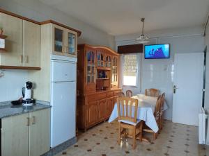 a kitchen with a table and a dining room at Vistas Al Mar E Isla De La Toja in O Grove