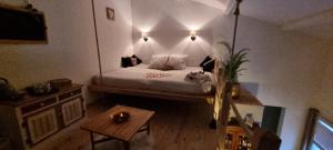 a bedroom with a bed with lights on the wall at Cocoon Espace Détente in Pierrelatte