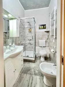 a bathroom with a sink and a toilet and a shower at B&B girasole in Verona