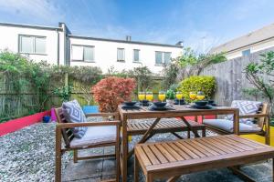 a patio with a table and chairs with drinks on it at Spacious 3 Bed Home in Cheltenham